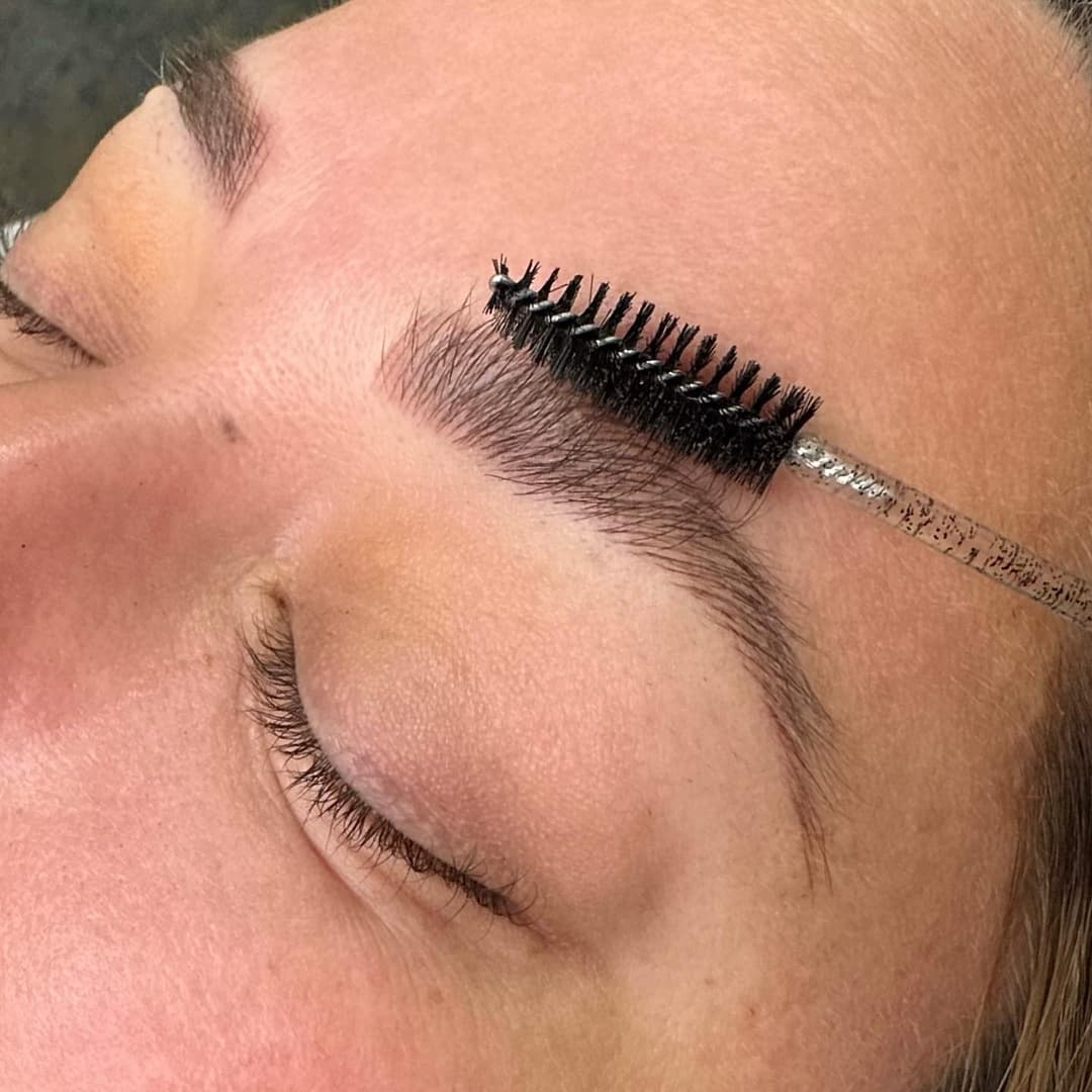 Microblading tools next to eyebrow